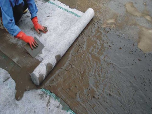 Self adhesive wet laid waterproof membrane